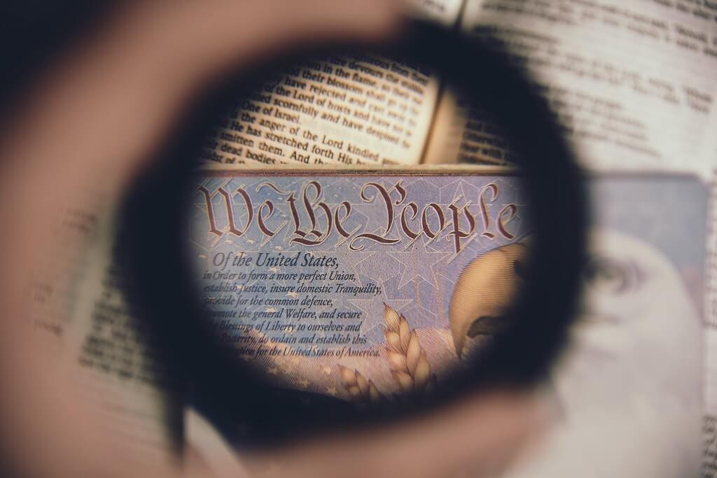 Photo shows a view of the first words of the US Constitution:   We the People. These words define our democracy.
