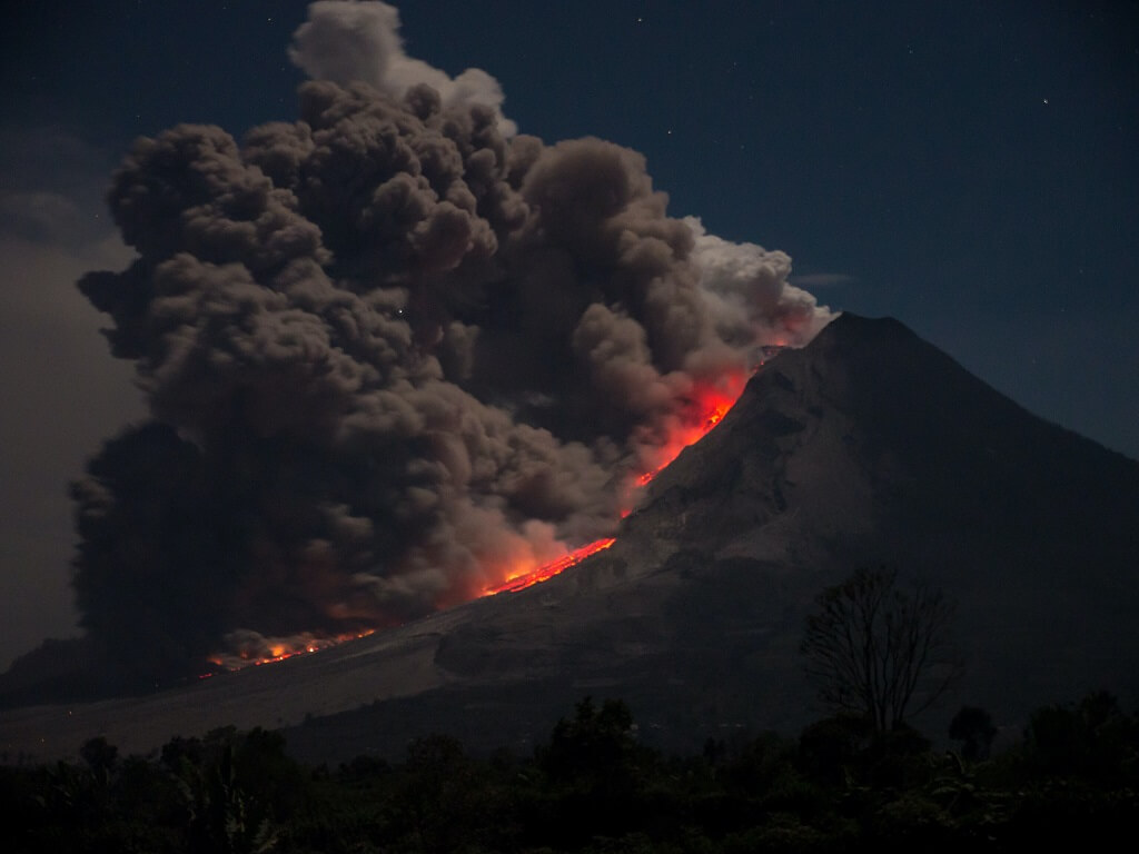 Stop losing your temper and reacting like an erupting volcano . The photo shows huge billows of gray smoke rising from the fiery interior of a mountain.